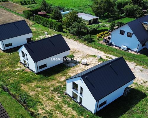 Nowe domy w sąsiedztwie terenów zielonych / Ujazd